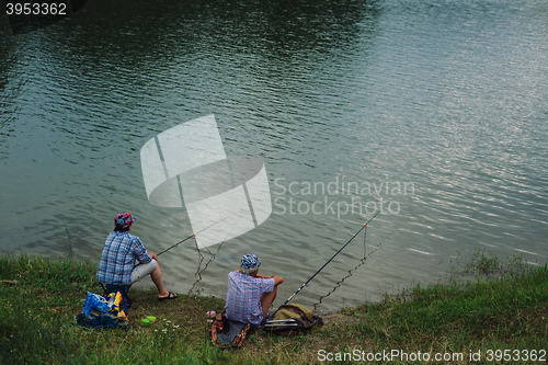 Image of Couple catches fish with a fishing rod