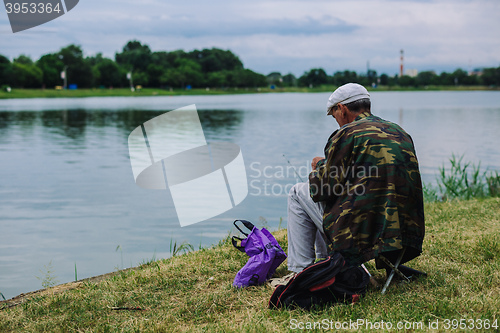 Image of Man catches fish with a fishing rod