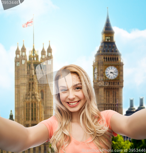 Image of happy smiling young woman taking selfie