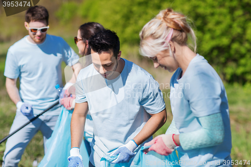 Image of volunteers with garbage bags cleaning park area