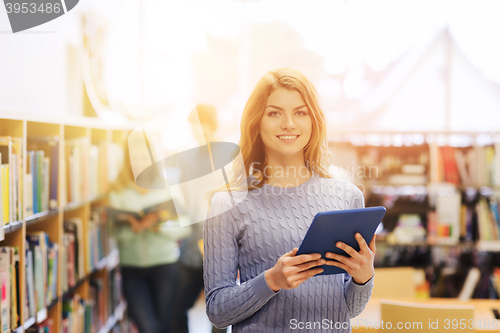 Image of happy student girl with tablet pc in library