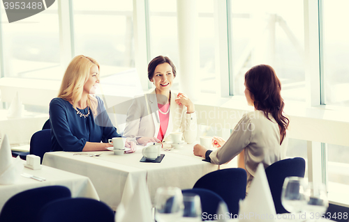 Image of women drinking coffee and talking at restaurant