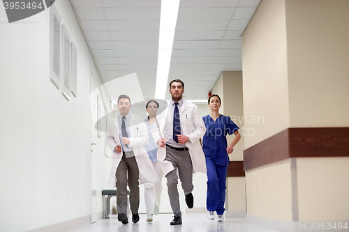 Image of group of medics walking along hospital