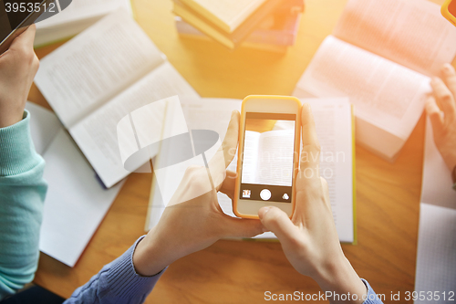 Image of students with smartphones making cheat sheets