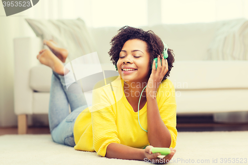Image of happy african woman with smartphone and headphones