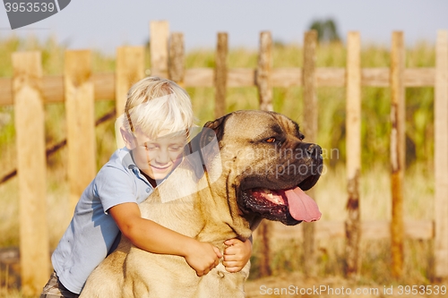 Image of Little boy with large dog