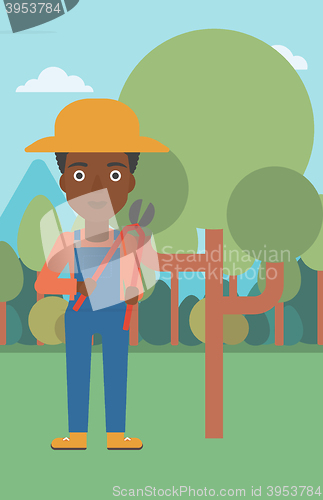 Image of Farmer with pruner in garden.