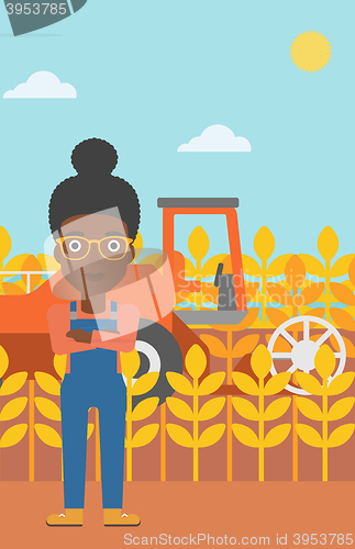 Image of Woman standing with combine on background.