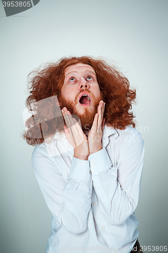 Image of Portrait of young man with shocked facial expression