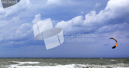 Image of Power kite in sea and cloudy dark sky