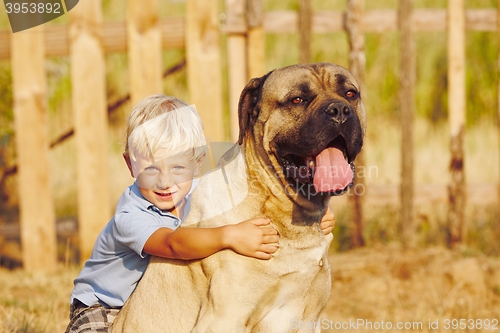 Image of Little boy with large dog