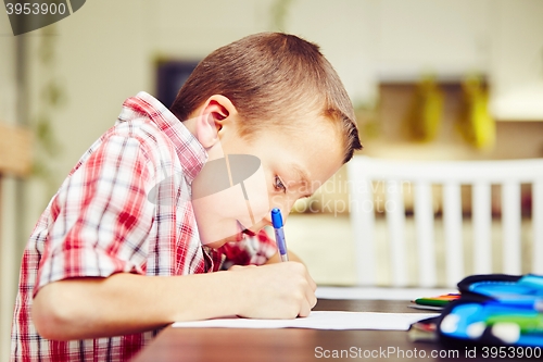 Image of Boy is doing homework 