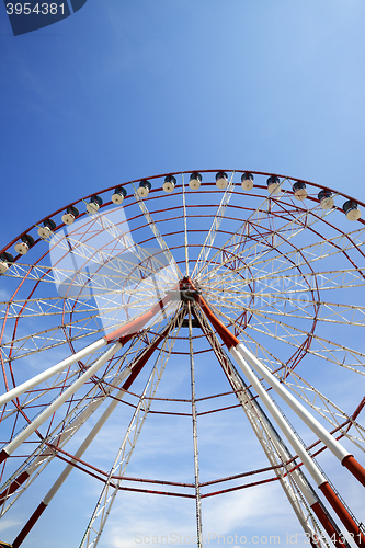 Image of Ferris wheel and blue sky in sun day