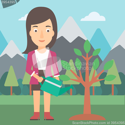 Image of Woman watering tree with light bulbs.