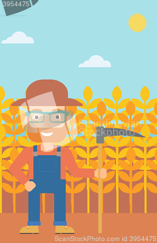 Image of Farmer on the field with scythe.