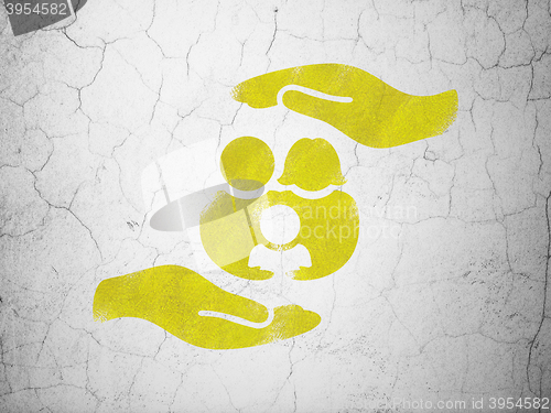 Image of Insurance concept: Family And Palm on wall background