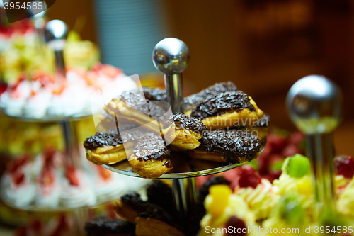 Image of Dessert table for party. akes and sweetness. Shallow dof