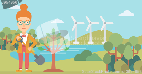 Image of Woman plants tree.