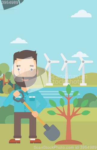 Image of Man plants tree.
