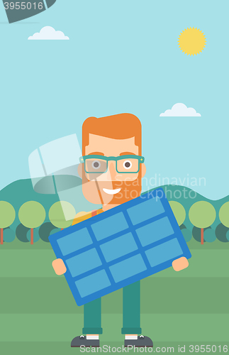 Image of Man holding solar panel.