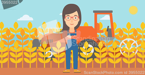 Image of Woman standing with combine on background.