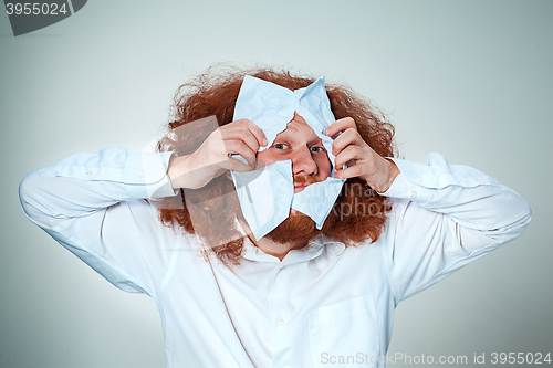 Image of Angry man tear out paper