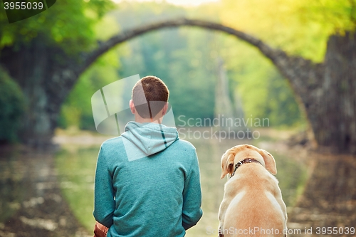 Image of Pensive man sitting with his dog