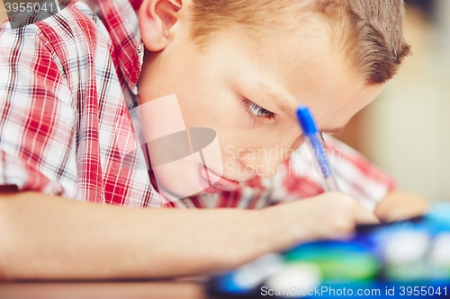 Image of Boy is doing homework