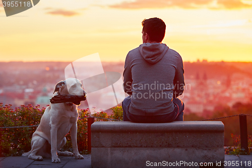 Image of Man with dog at the sunrise