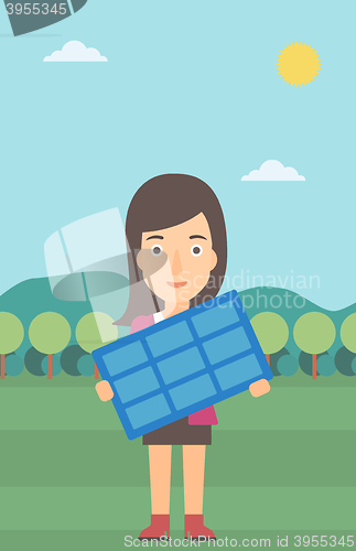 Image of Woman holding solar panel.