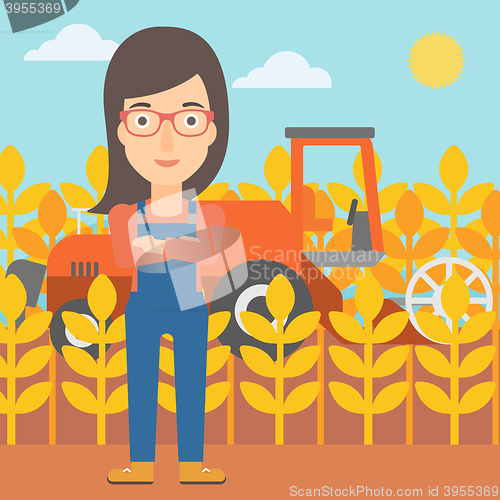 Image of Woman standing with combine on background.