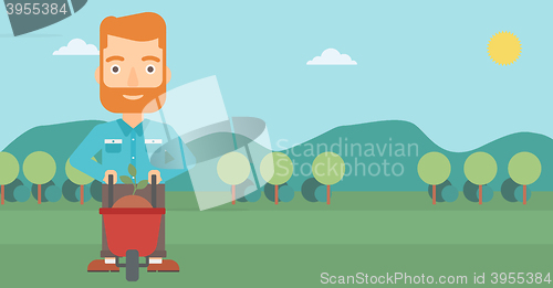 Image of Man with plant and wheelbarrow.