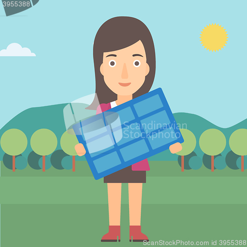 Image of Woman holding solar panel.
