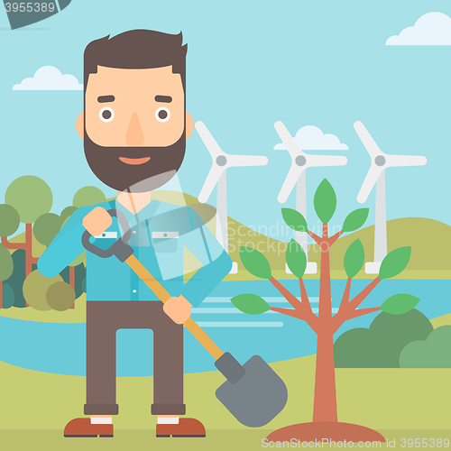 Image of Man plants tree.