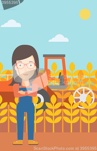 Image of Woman standing with combine on background.