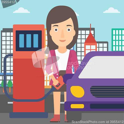 Image of Woman filling up fuel into car.