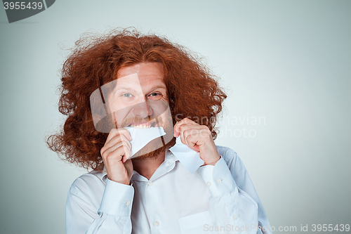 Image of Angry man tear out paper