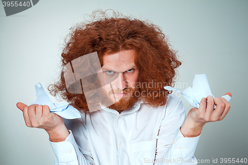 Image of Angry man tear out paper