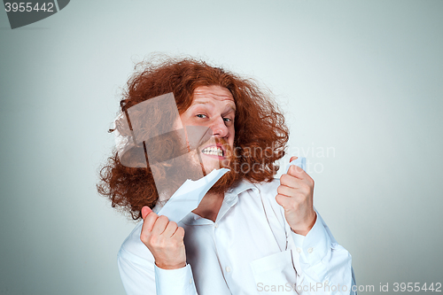 Image of Angry man tear out paper