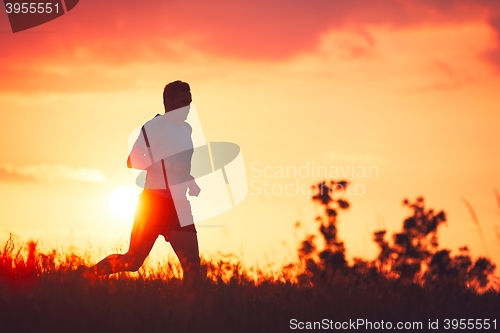 Image of Athletic runner at the sunset