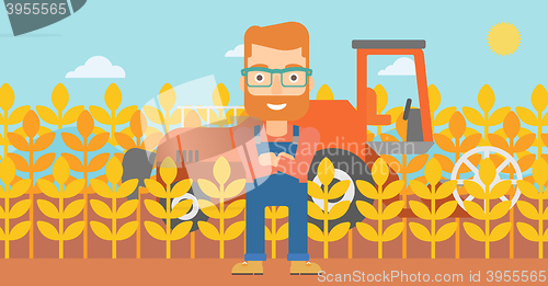 Image of Man standing with combine on background.