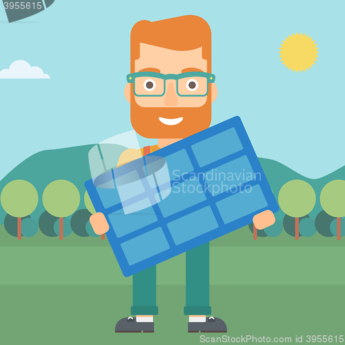 Image of Man holding solar panel.