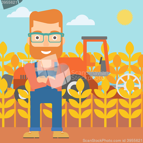 Image of Man standing with combine on background.