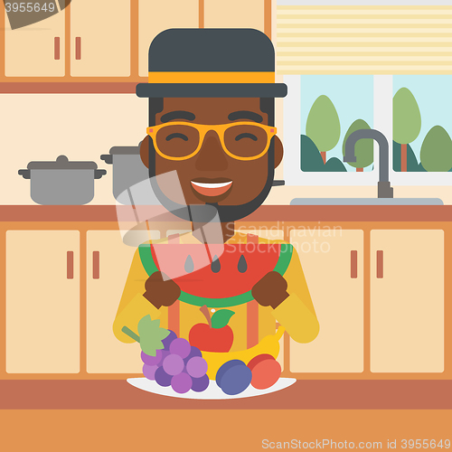 Image of Man eating watermelon.