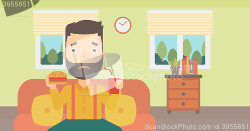 Image of Man eating hamburger. 