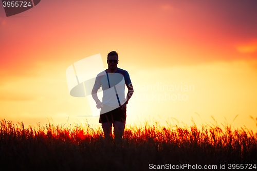 Image of Athletic runner at the sunset