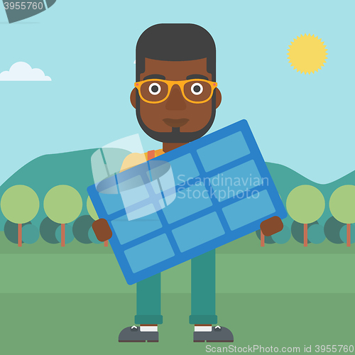 Image of Man holding solar panel.