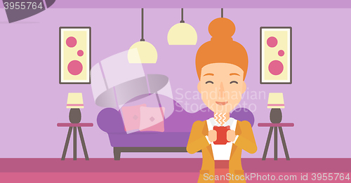 Image of Woman sitting with cup of coffee.