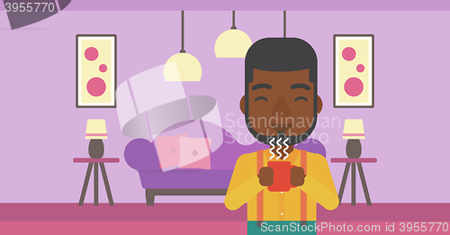 Image of Man holding cup of coffee.