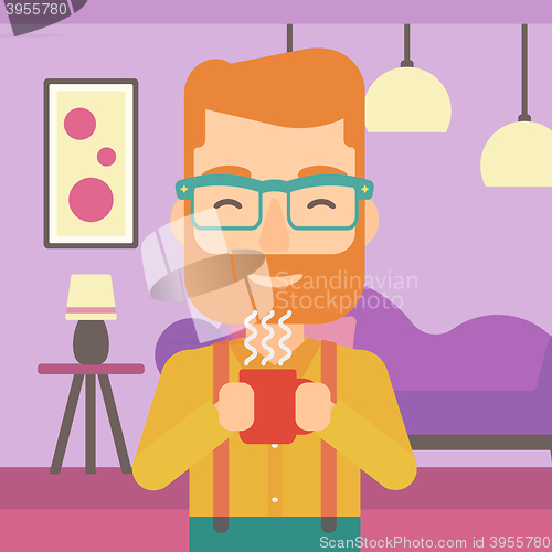 Image of Man holding cup of coffee.